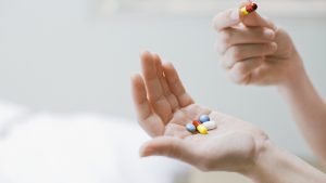 Woman taking vitamins and supplements