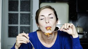 Portrait of woman eating spaghetti