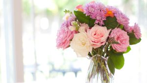 Bouquet of flowers on table near window