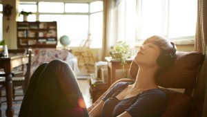 Young woman relaxing with headphones at home