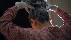 A woman dye her hair by herself
