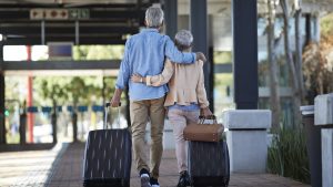 Senior couple walking together on public transport station