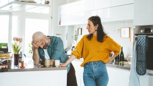 Serious woman arguing with man in kitchen at home