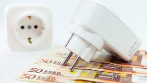 Euro banknotes and power plug on white background