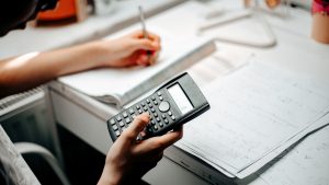 medium shot of teenager studying and doing homeworks