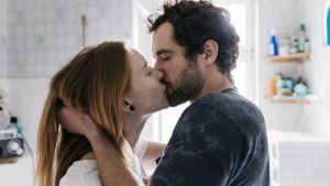 Couple Romantically Engaged In A Kiss