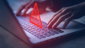 System hacked warning alert on notebook (Laptop). Cyber attack on computer network, Virus, Spyware, Malware or Malicious software. Cyber security and cybercrime. Compromised information internet.