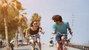 Woman chasing man while riding bicycle