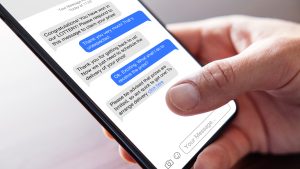 Person reading scam messages on mobile phone