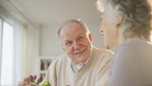 Senior couple eating salads together