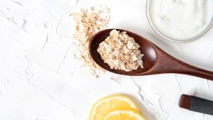 Homemade cosmetics with cucumber and yogurt and oatmeal on a white background. Ingredients for the mask