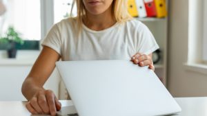 Hands close and open a laptop