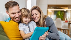 Dos padres juegan con su hijo (Getty)