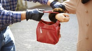 Mugger stealing handbag