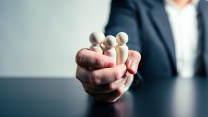 CEO Influence Business Agreements and Employee Dismissals workforce labor businessman hand background. Tyrant and corruption concept.