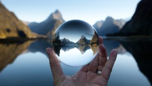 Man holding crystal ball in landscape